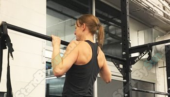 Sidney performing a pull up exercise